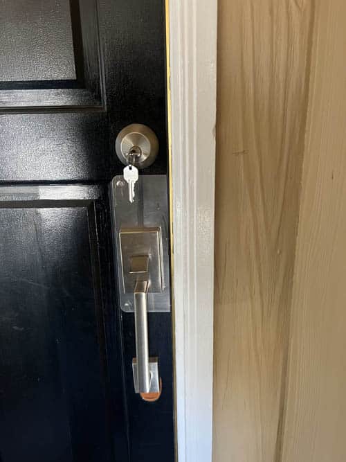 New deadbolt, doorhandle, and wrap plate installed on a residential door.