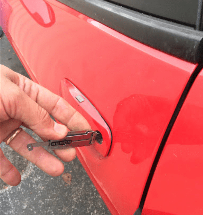Locksmith using a Lishi tool to unlock a car door